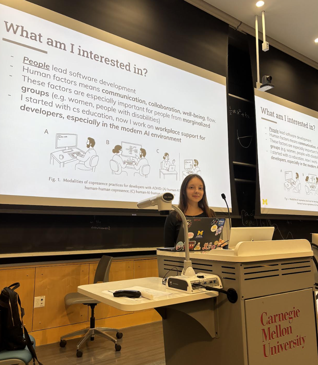 Veronica standing by a podium saying Carnegie Mellon University and behind her is a powerpoint slide that says human factors of software engineering.