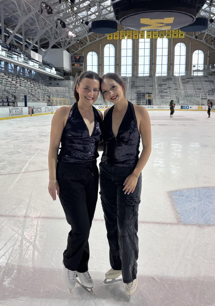 Veronica standing with Meredith Parr on the ice at Yost Ice arena in matching outfits (blue top with black pants for the Y2K theme).